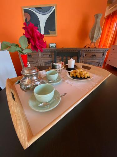 a table with two bowls and a plate of food on it at Orecchie di Lepre in Siracusa
