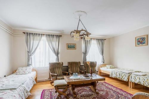 a living room with a table and chairs at Gemenc Vendégház in Hercegszántó
