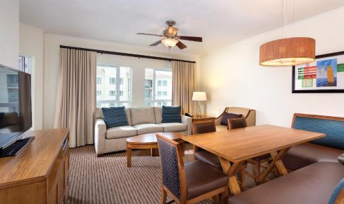 a living room with a table and a dining room at Club Wyndham Oceanside Pier Resort in Oceanside