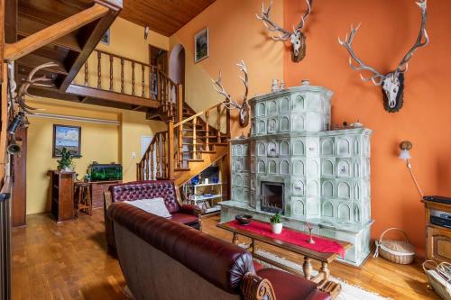 a living room with a couch and a fireplace at Gemenc Vendégház in Hercegszántó