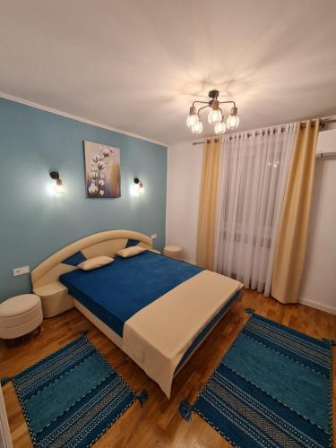 een slaapkamer met een groot bed en blauwe muren bij White Stone in Sibiu