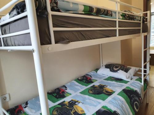 a bunk bed with a motorcycle quilt on it at Malavi DV2 top center apartment Ruse in Ruse