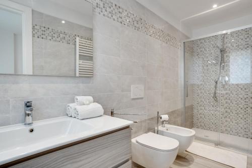 a bathroom with a sink and a toilet and a shower at DREAM Holiday Houses in Cernobbio