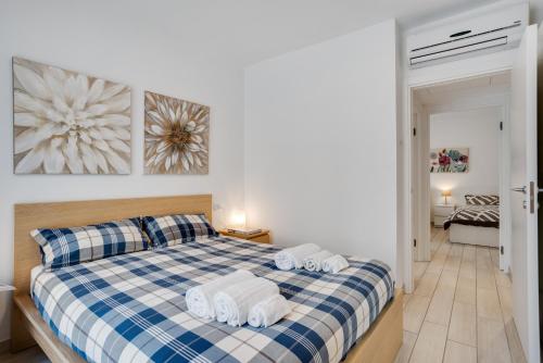 a bedroom with a blue and white bed with towels on it at DREAM Holiday Houses in Cernobbio