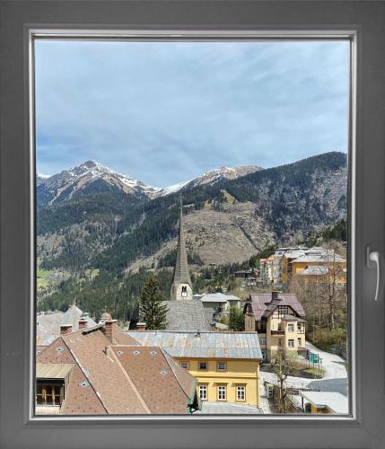 a view from a window of a town with a church at Das Schider - Boutique Apart-Hotel in Bad Gastein