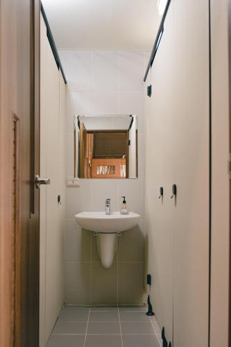 a bathroom with a sink and a mirror at Destination Inn in Magong