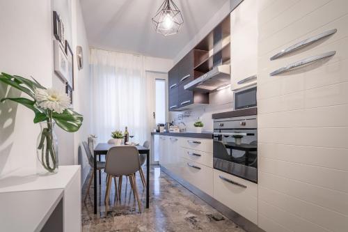 a kitchen with a table and a dining room at 4 Star Bologna Train Station - Self Check-In in Bologna