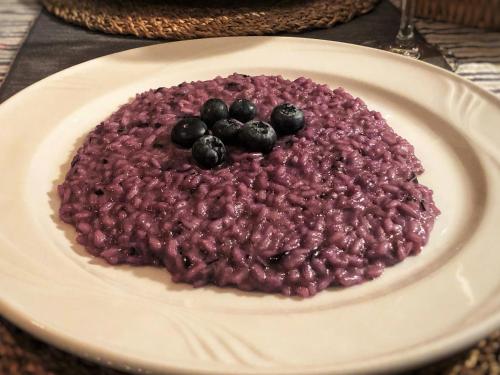 a plate of beans and blueberries on a table at Baita Dal Vikingo in Sorico