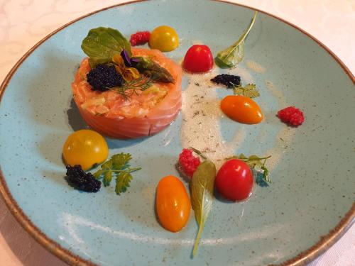 a plate of food with tomatoes and vegetables on it at Chambres et Table d'hôtes "La Pastorale Gourmande" FR - NE - EN - DE - IT in Marcollin