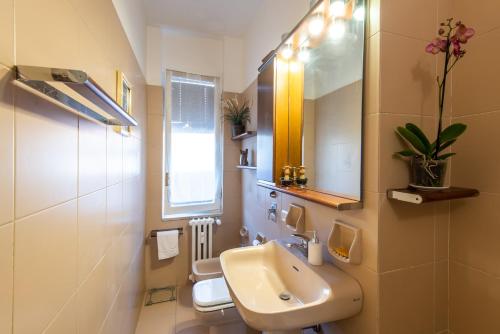 a bathroom with two toilets and a sink and a mirror at Milano Guest House in Milan