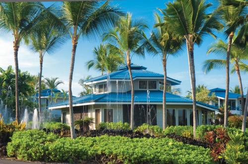 a house on the beach with palm trees at Wyndham Mauna Loa Village in Kailua-Kona