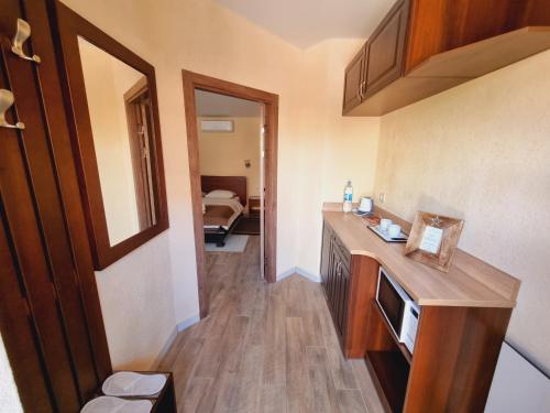 a room with a kitchen with a sink and a mirror at НИК аэро in Kharkiv