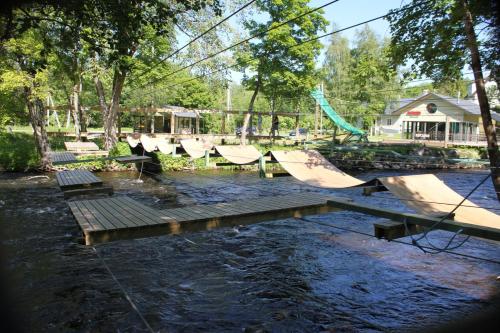 a park with a playground with wooden ramps in the water at Lontova puhkemaja in Kunda