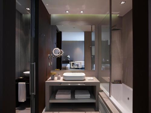a bathroom with a sink and a mirror at Aqua Blu Boutique Hotel & Spa, Adults Only- Small Luxury Hotels of the World in Kos