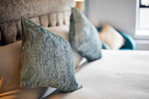 two pillows sitting on top of a couch at Handel's Hotel in Dublin