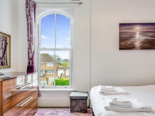 a bedroom with a bed and a window at A Spacious Cosy Holiday Retreat! in Whitstable