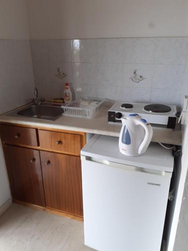 a small kitchen with a sink and a stove at Katerina Studios in Laganas
