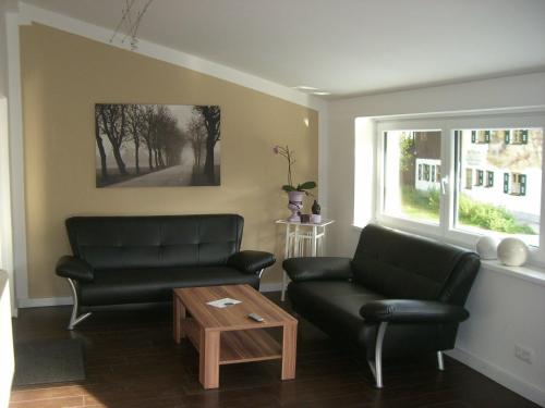 a living room with a couch and a table at Pension Kellerer in Raubling