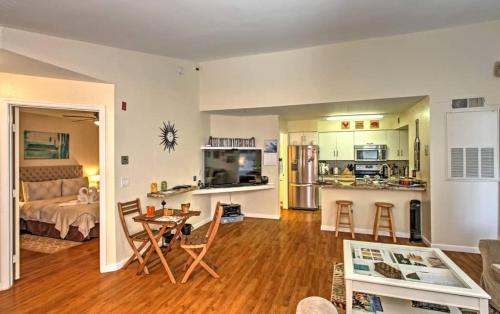 a living room with a bed and a kitchen with a table at Disney Adjacent in Kissimmee