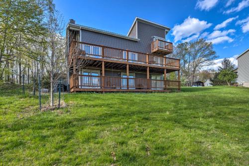 a large house with a deck on a lawn at Pet-Friendly Massanutten Resort Home with Yard! in McGaheysville