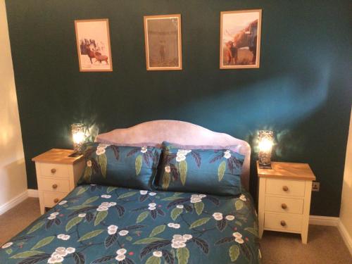 a bedroom with a bed and two night stands at Burn View in Stronachlachar