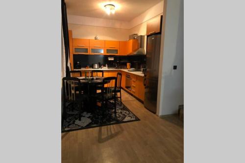 a kitchen with a table and a refrigerator at Sunshine villa Dzhigurovo in Sandanski