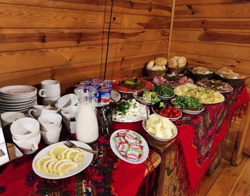 a table with a bunch of food on it at Karczma Regionalna Młyn -pokoje gościne in Zwierzyniec