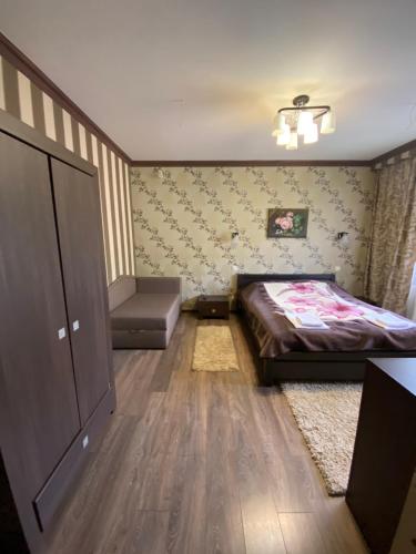 a bedroom with a bed and a dresser in it at Приватна садиба Європа in Solochin
