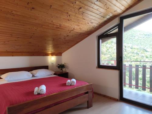 a bedroom with a bed with white shoes on it at Pansion Alen - Dugi otok in Luka