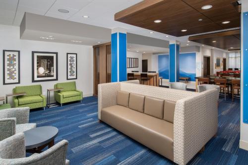 a lobby with a couch and chairs and tables at Holiday Inn Express Pensacola Downtown, an IHG Hotel in Pensacola