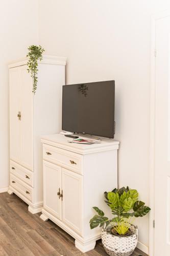 a white cabinet with a tv on top of it at ALBERT RESIDENCE Aparthotel in Braşov