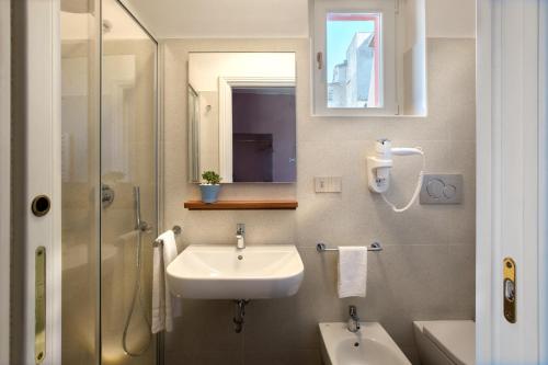 a bathroom with a sink and a shower at Dimora del Leone Gaeta in Gaeta
