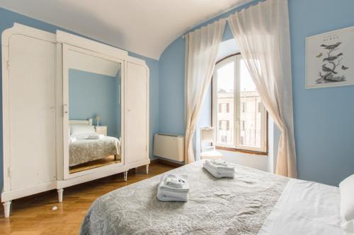 a blue bedroom with a bed and a mirror at Liberty Colosseo in Rome