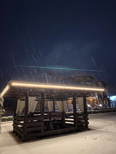 a building in the snow with lights on it at Приватна садиба Європа in Solochin