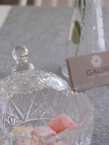 a glass bottle with rocks in a glass bowl at Galini Rooms & Apartments in Finikas