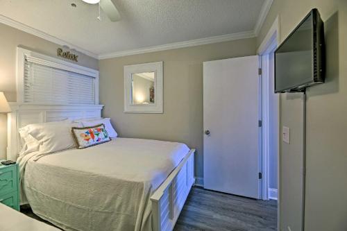 a bedroom with a bed and a flat screen tv at Walk to Beach Ocean-View Atlantic Beach Condo! in Atlantic Beach