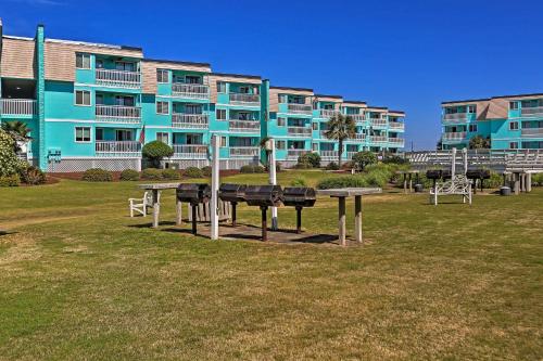 a large apartment building with a picnic table in a park at Walk to Beach Ocean-View Atlantic Beach Condo! in Atlantic Beach