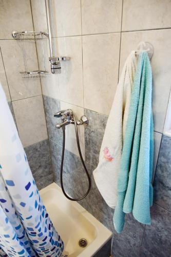 a bathroom with a shower and a sink with towels at Apartments Novotny in Rab