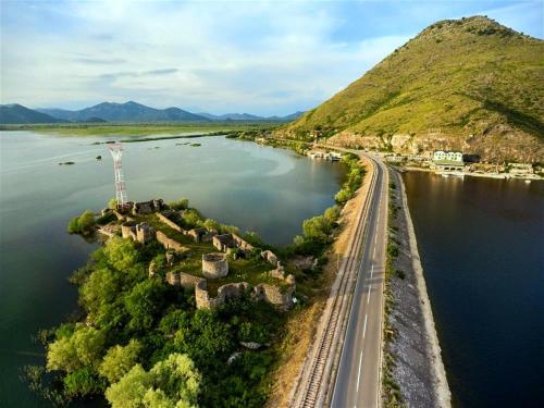 an island in the middle of a body of water at Draga`s rooms in Virpazar