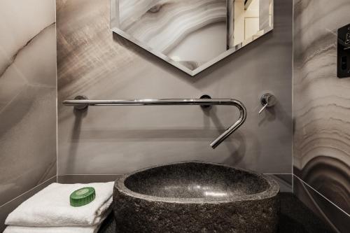 a bathroom with a sink and a tub at Hotel Pjazza Merkanti - Boutique Living in Valletta