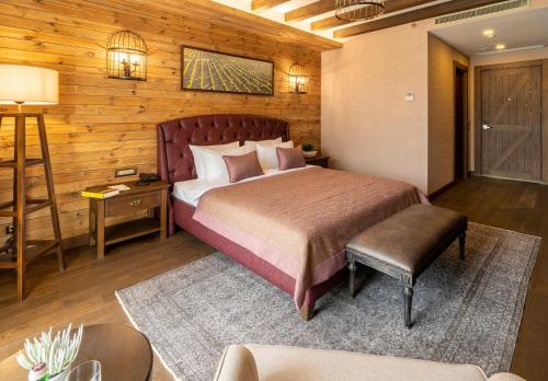 a bedroom with a bed and a wooden wall at Bengodi Boutique Hotel in Eceabat