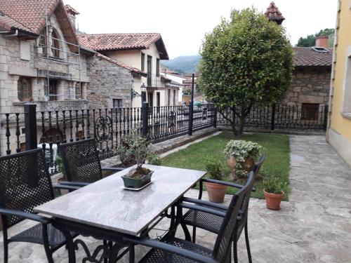 a wooden table and chairs on a patio at Posada Carpe Diem in Liérganes