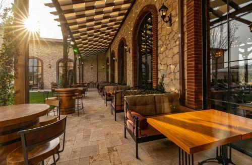 a patio with tables and chairs in a restaurant at Bengodi Boutique Hotel in Eceabat