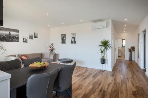 a living room with a table and a couch at Belvedere Holidays in Novigrad Istria