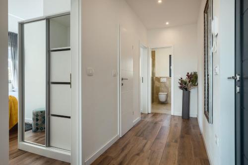 a hallway with white walls and a large mirror at Belvedere Holidays in Novigrad Istria