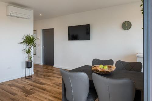 a living room with a table and a couch at Belvedere Holidays in Novigrad Istria