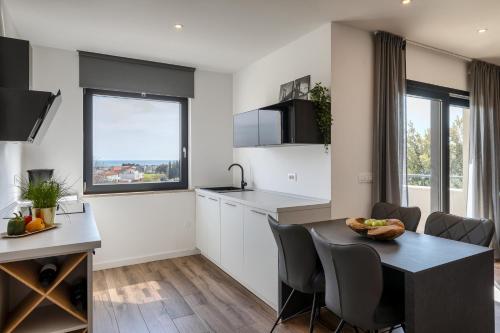 a kitchen and dining room with a table and chairs at Belvedere Holidays in Novigrad Istria