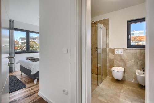 a bathroom with a shower and a toilet and a sink at Belvedere Holidays in Novigrad Istria