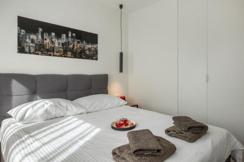 a bed with towels and a plate of food on it at Belvedere Holidays in Novigrad Istria