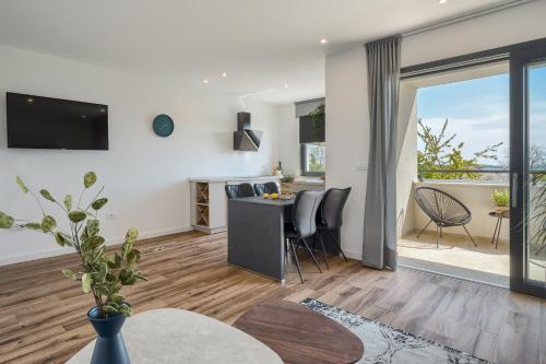 a kitchen and living room with a table and chairs at Belvedere Holidays in Novigrad Istria